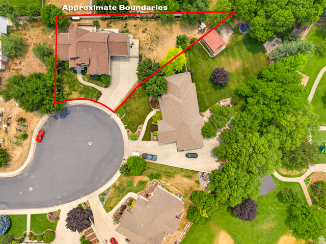 1279 West 1500th Street North Mapleton, UT 84664 - Photo 75 of 83 Expansive property with a cul-de-sac location, featuring a mature tree-lined perimeter, a broad concrete driveway, and a well-maintained lawn