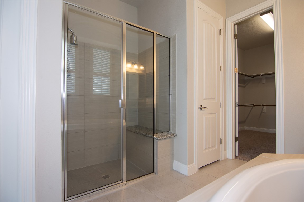 3901 Rhythmic Drive Pflugerville, TX 78660 - Photo 16 of 40 a bathroom with a glass shower door