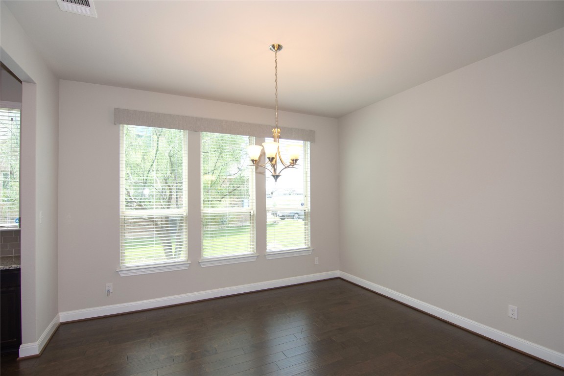 3901 Rhythmic Drive Pflugerville, TX 78660 - Photo 4 of 40 an empty room with wooden floor and windows
