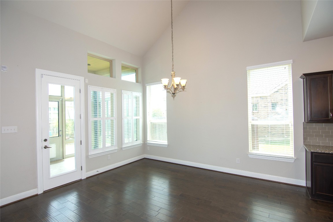 3901 Rhythmic Drive Pflugerville, TX 78660 - Photo 10 of 40 a view of an empty room with wooden floor and a window