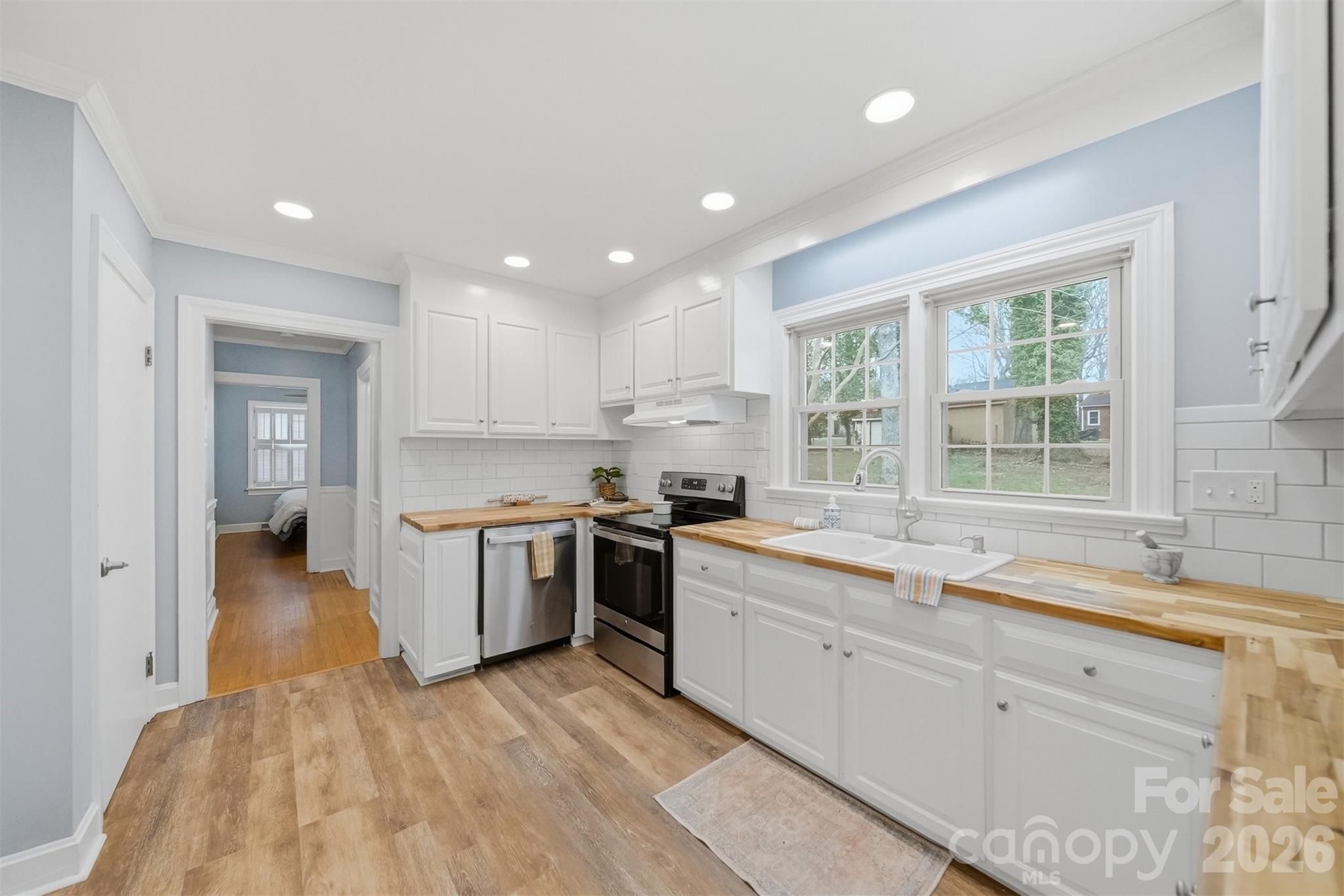 705 2nd Avenue Northeast Conover, NC 28613 - Photo 13 of 43 a kitchen with a sink stove and cabinets