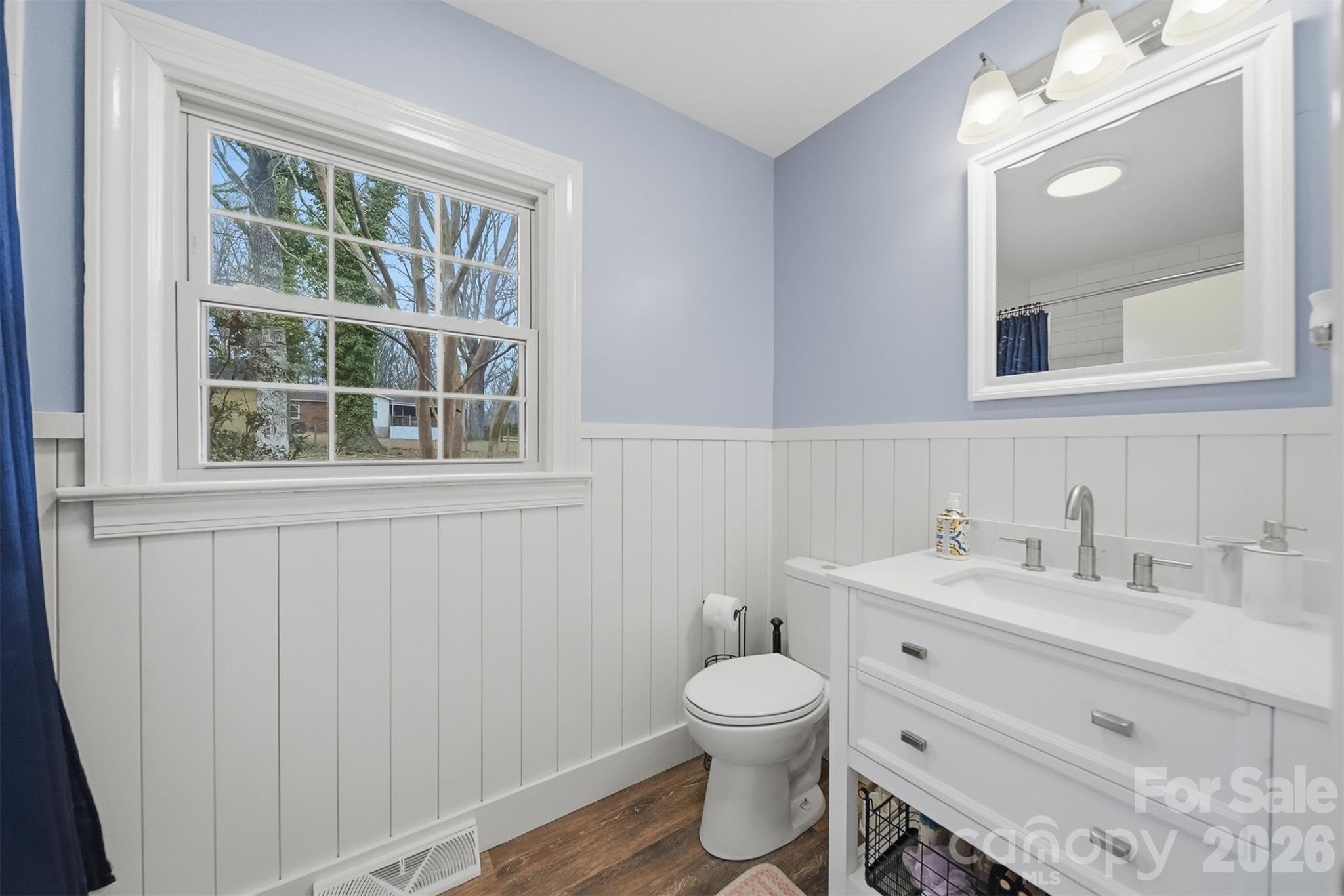 705 2nd Avenue Northeast Conover, NC 28613 - Photo 26 of 43 a bathroom with a toilet sink and mirror