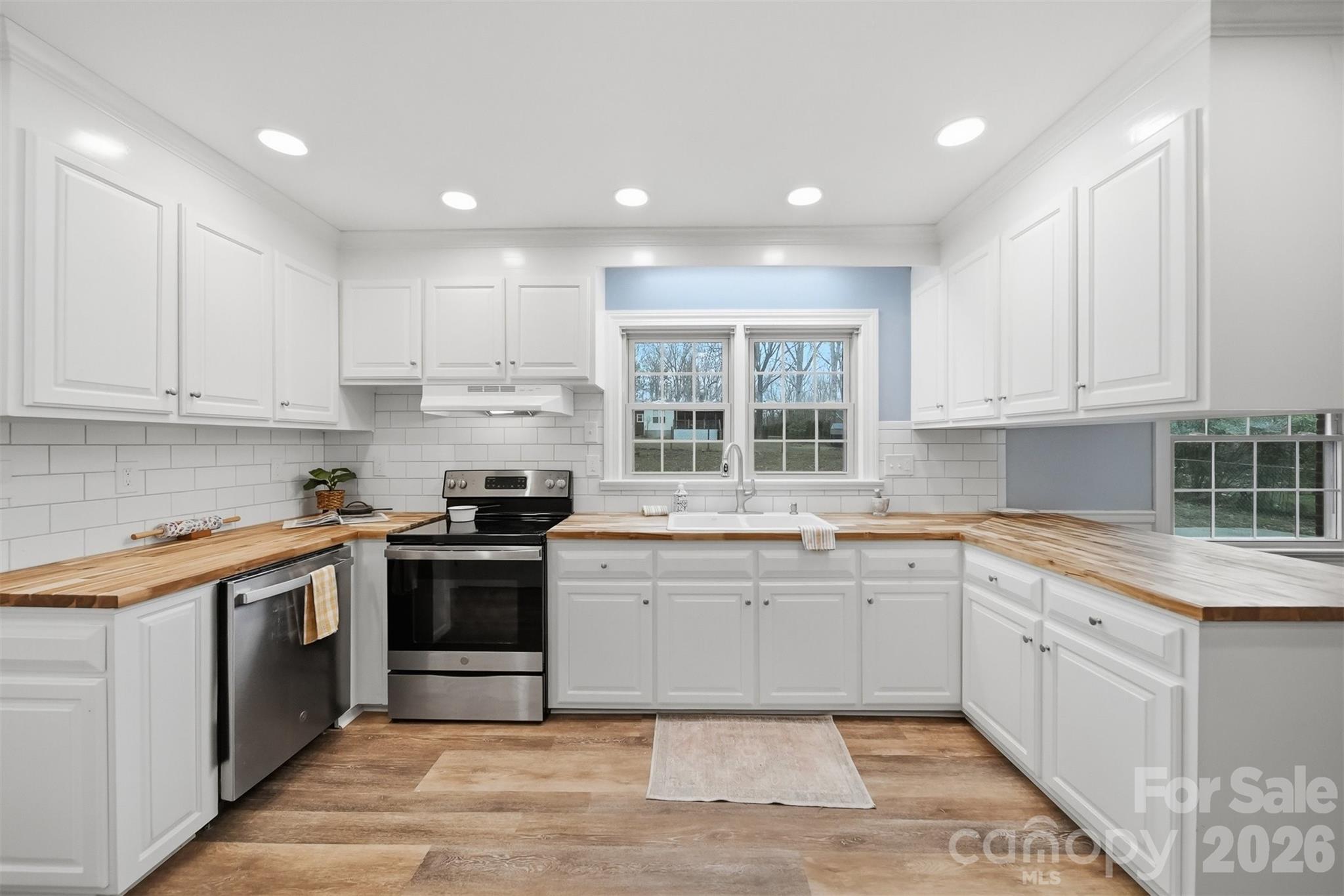 705 2nd Avenue Northeast Conover, NC 28613 - Photo 5 of 43 a kitchen with a sink stove and cabinets