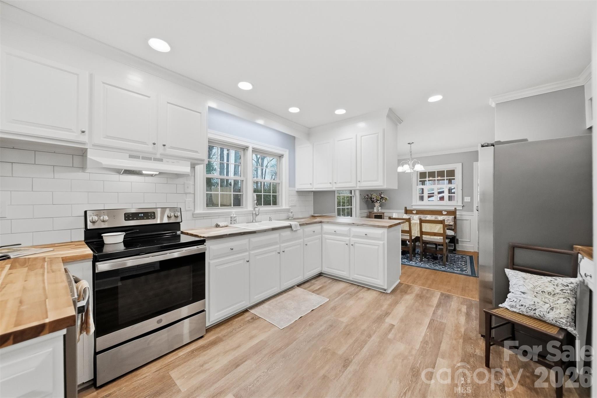 705 2nd Avenue Northeast Conover, NC 28613 - Photo 6 of 43 a kitchen with a sink wooden floor and stainless steel appliances
