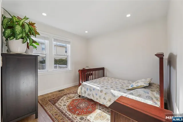 a bedroom with a bed and a potted plant