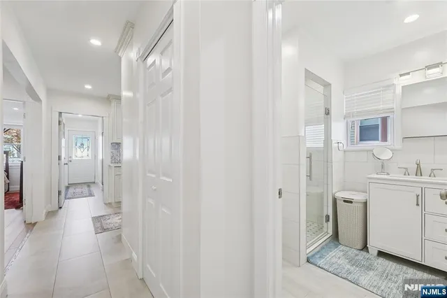 a bathroom with a sink a toilet a mirror and shower