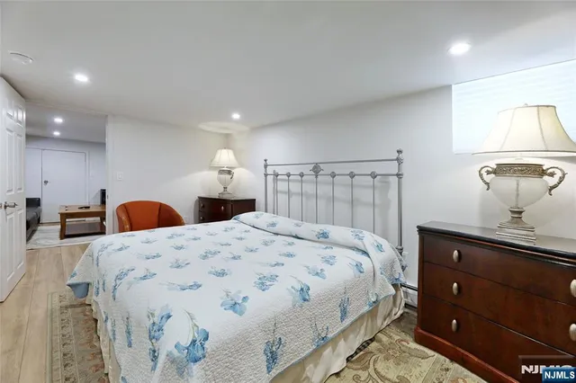 a large bedroom with a bed and a dresser