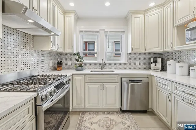 a kitchen with cabinets appliances and a counter space