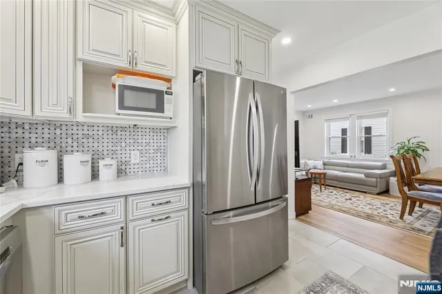 a kitchen with stainless steel appliances a refrigerator sink and cabinets