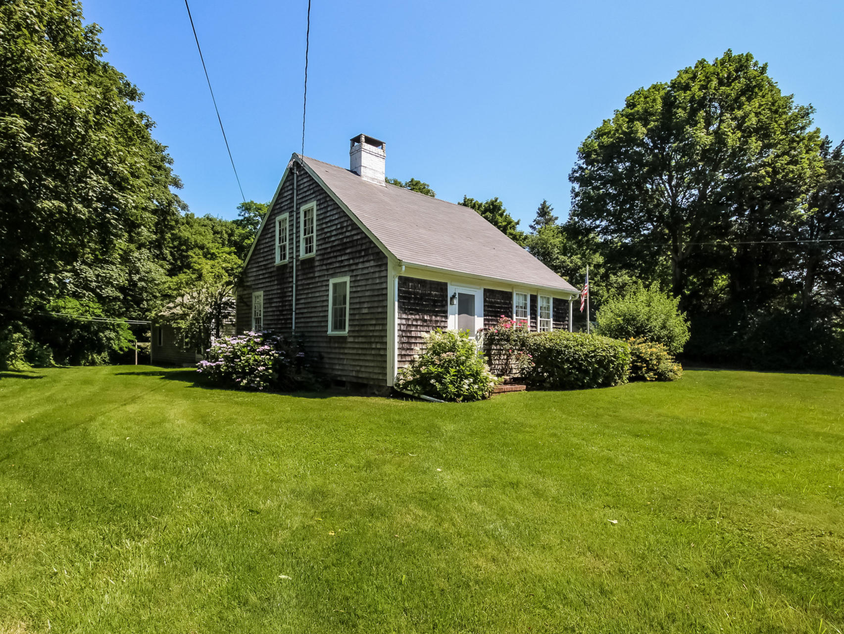 12 Pochet Road Orleans, MA 02653 - Photo 3 of 25 a front view of a house with a garden