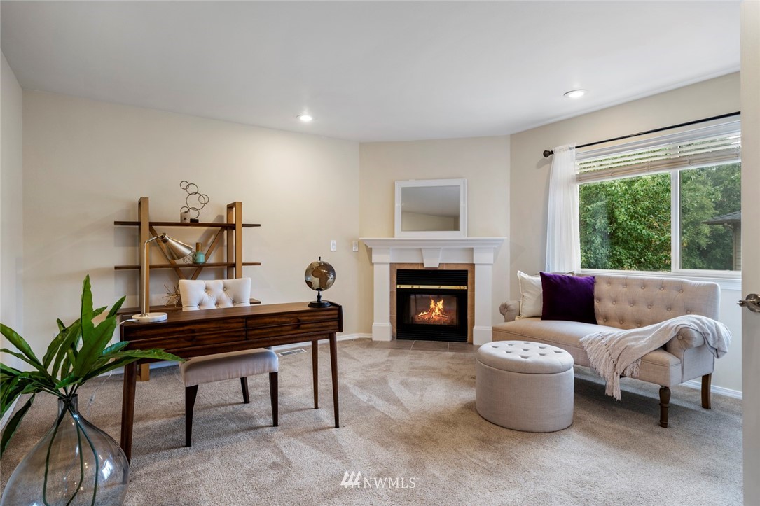 23100 14th Drive Southeast Bothell, WA 98021 - Photo 22 of 30 a living room with furniture a fireplace and a large window