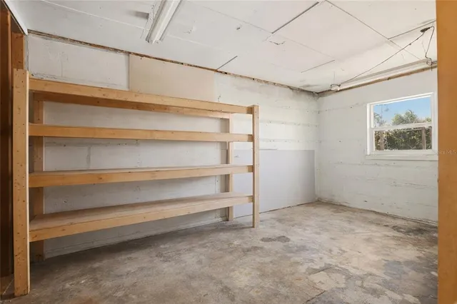 a view of a kitchen with a sink and wooden cabinets