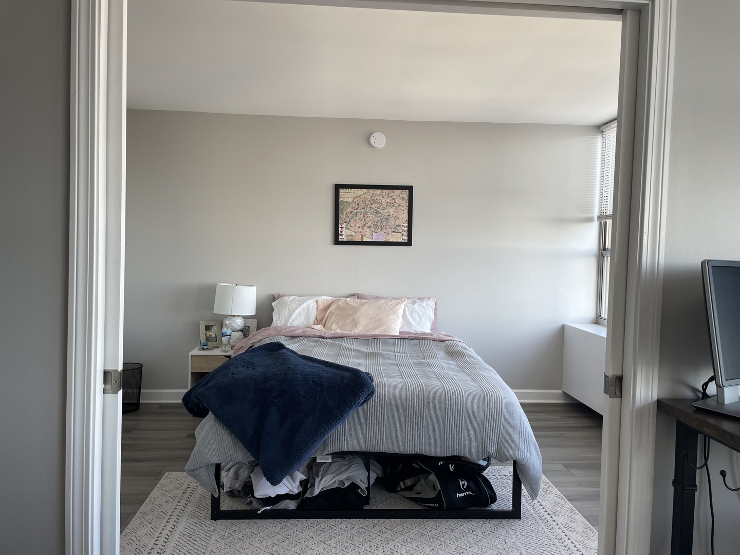 655 West Irving Park Road, Unit 1807 Chicago, IL 60613 - Photo 12 of 23 a bedroom with a bed a couch and a flat screen tv