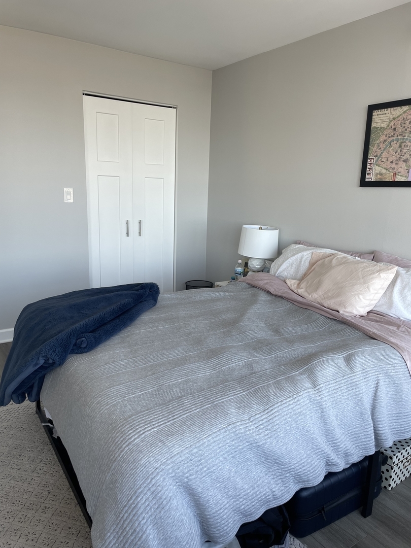 655 West Irving Park Road, Unit 1807 Chicago, IL 60613 - Photo 13 of 23 a bedroom with a bed and a night stand