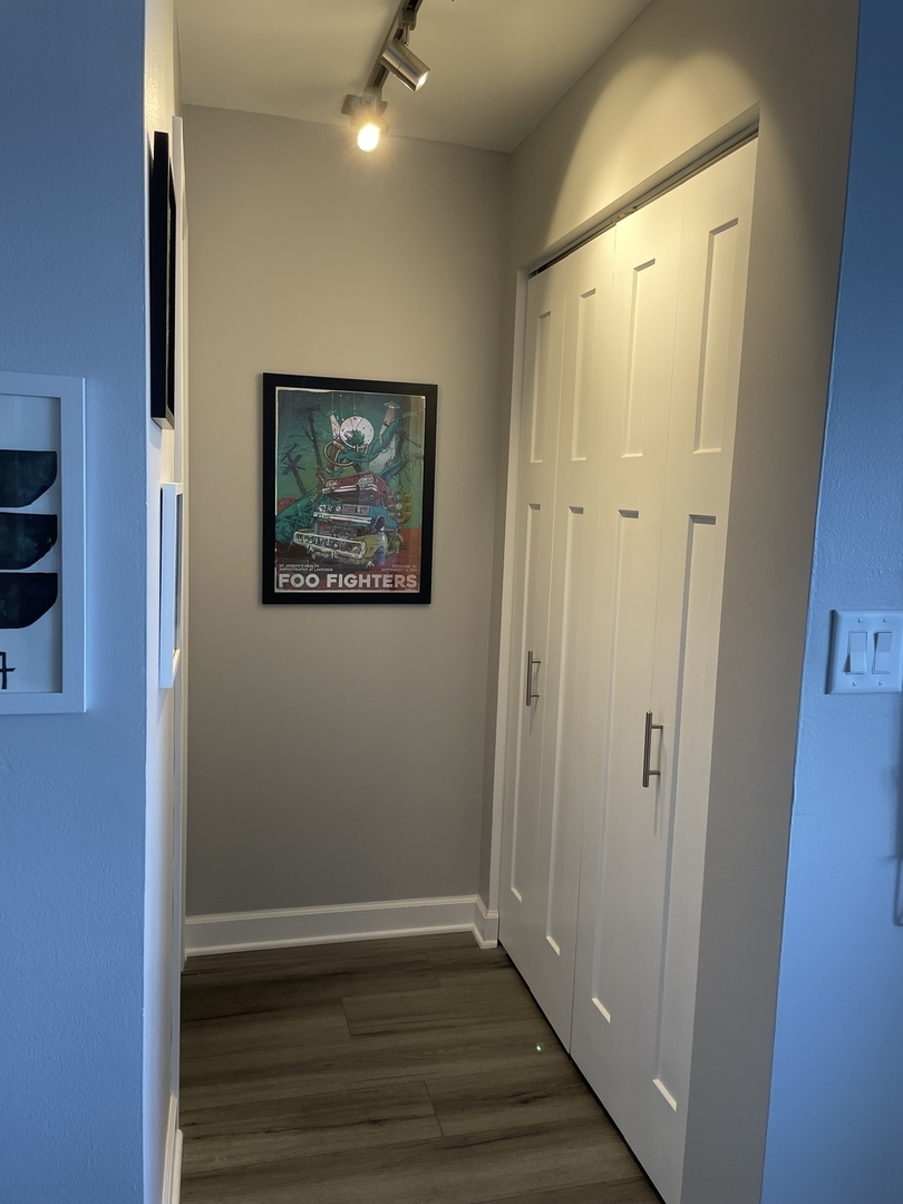 655 West Irving Park Road, Unit 1807 Chicago, IL 60613 - Photo 6 of 23 an empty room with wooden floor and windows
