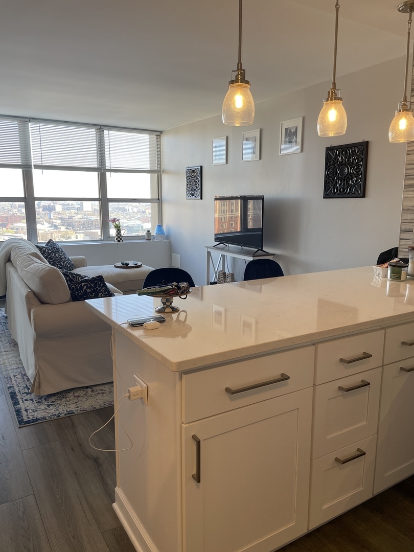 655 West Irving Park Road, Unit 1807 Chicago, IL 60613 - Photo 7 of 23 a kitchen with cabinets and window