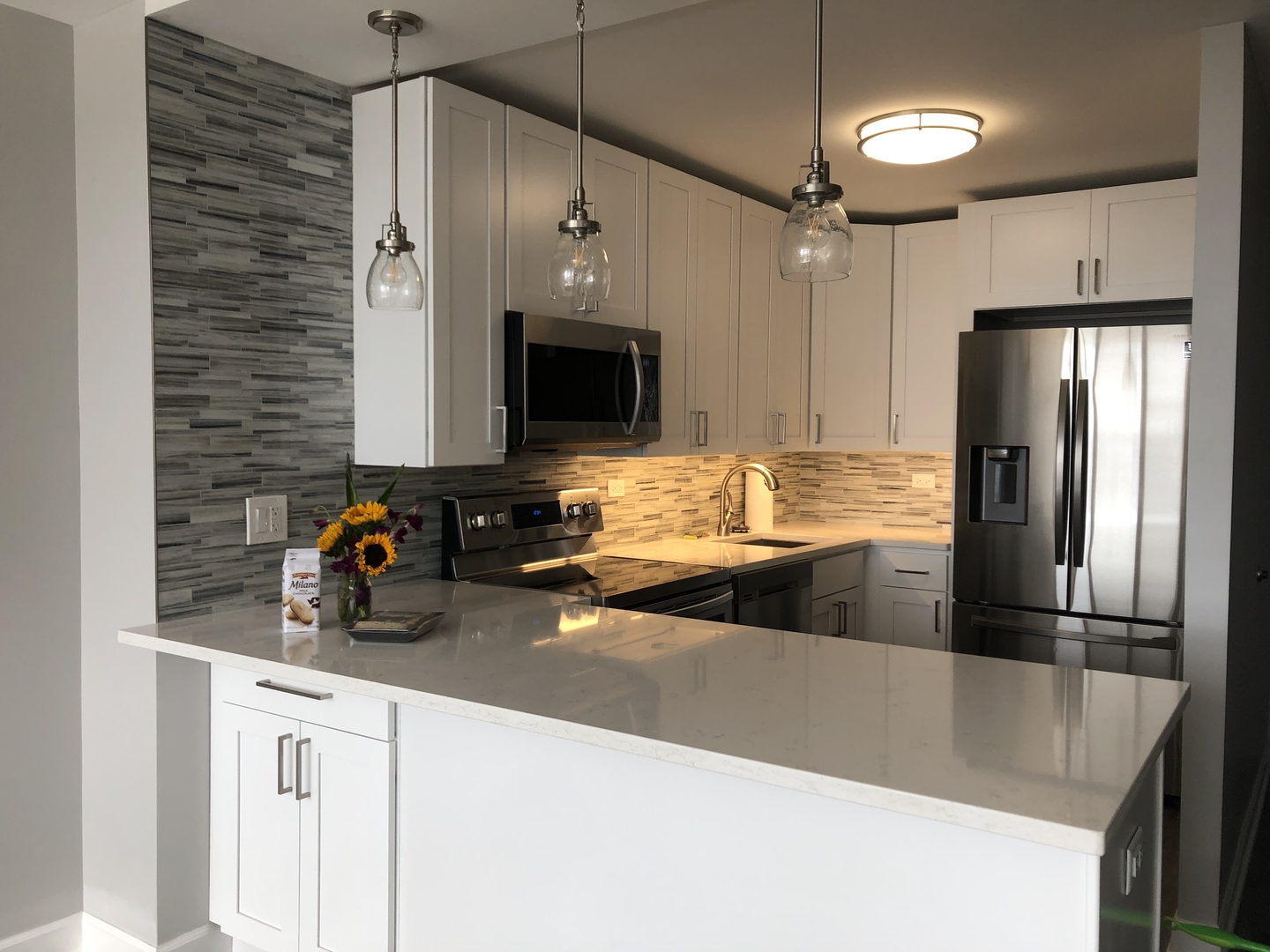 655 West Irving Park Road, Unit 1807 Chicago, IL 60613 - Photo 8 of 23 a kitchen with stainless steel appliances granite countertop a refrigerator and a sink