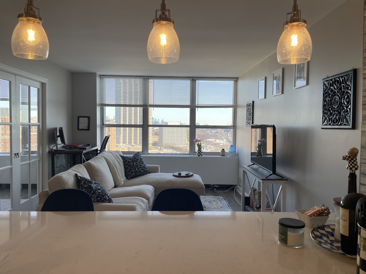 655 West Irving Park Road, Unit 1807 Chicago, IL 60613 - Photo 9 of 23 a living room with furniture and a flat screen tv