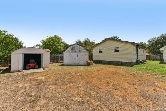 a view of a house with a yard and garage