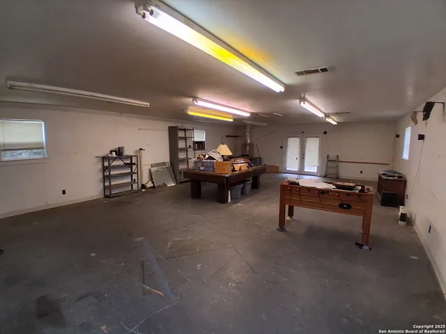 a living room with furniture and a dining table