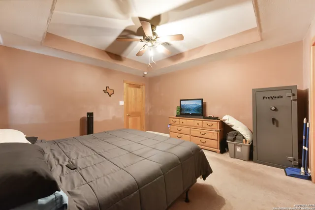 a bedroom with a large bed and a chandelier