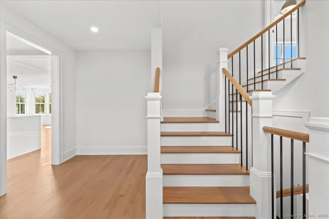 a view of entryway and hall with wooden floor
