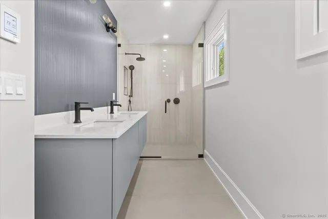 a bathroom with a sink a mirror and a shower