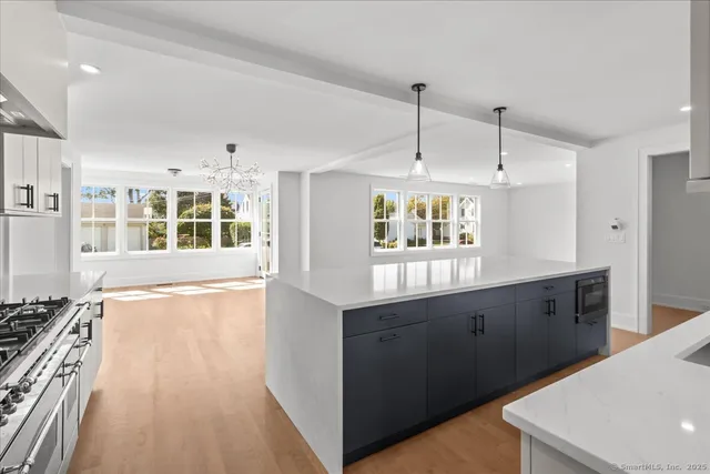 a kitchen with granite countertop a stove and a sink