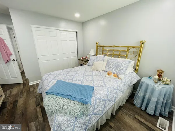 a bedroom with a bed and a mirror