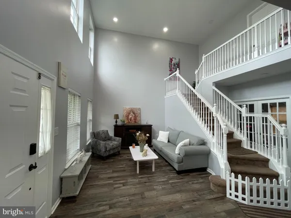 a living room with furniture and stairs