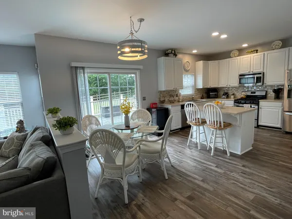 a living room with furniture a window and appliances