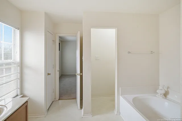 a bathroom with a bathtub and a sink