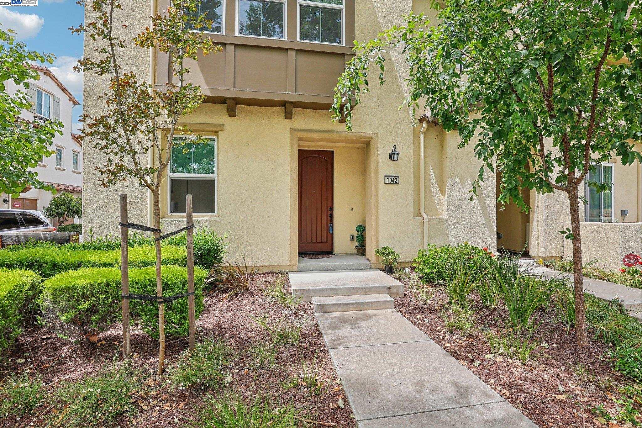 1042 South Monarch Road San Ramon, CA 94582 - Photo 1 of 1 a view of a house with a small yard plants and a large tree
