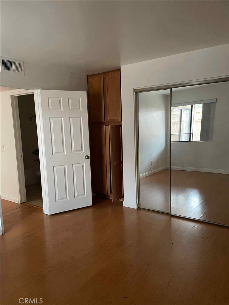 1315 Massachusetts Avenue, Unit 101 Riverside, CA 92507 - Photo 5 of 11 an empty room with windows and closet
