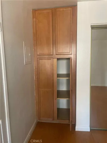 a view of wooden house with a chair and wooden fence