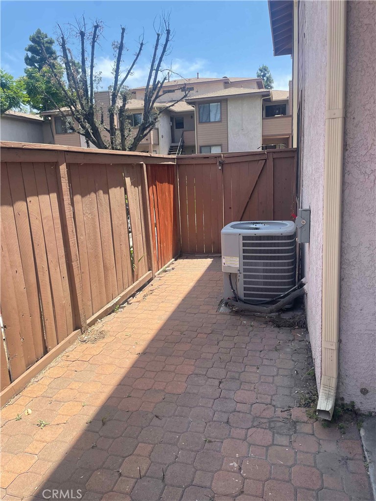 1315 Massachusetts Avenue, Unit 101 Riverside, CA 92507 - Photo 9 of 11 a view of wooden house with a chair and wooden fence