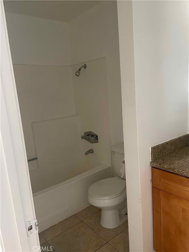 1315 Massachusetts Avenue, Unit 101 Riverside, CA 92507 - Photo 10 of 11 a white toilet sitting next to a bath tub