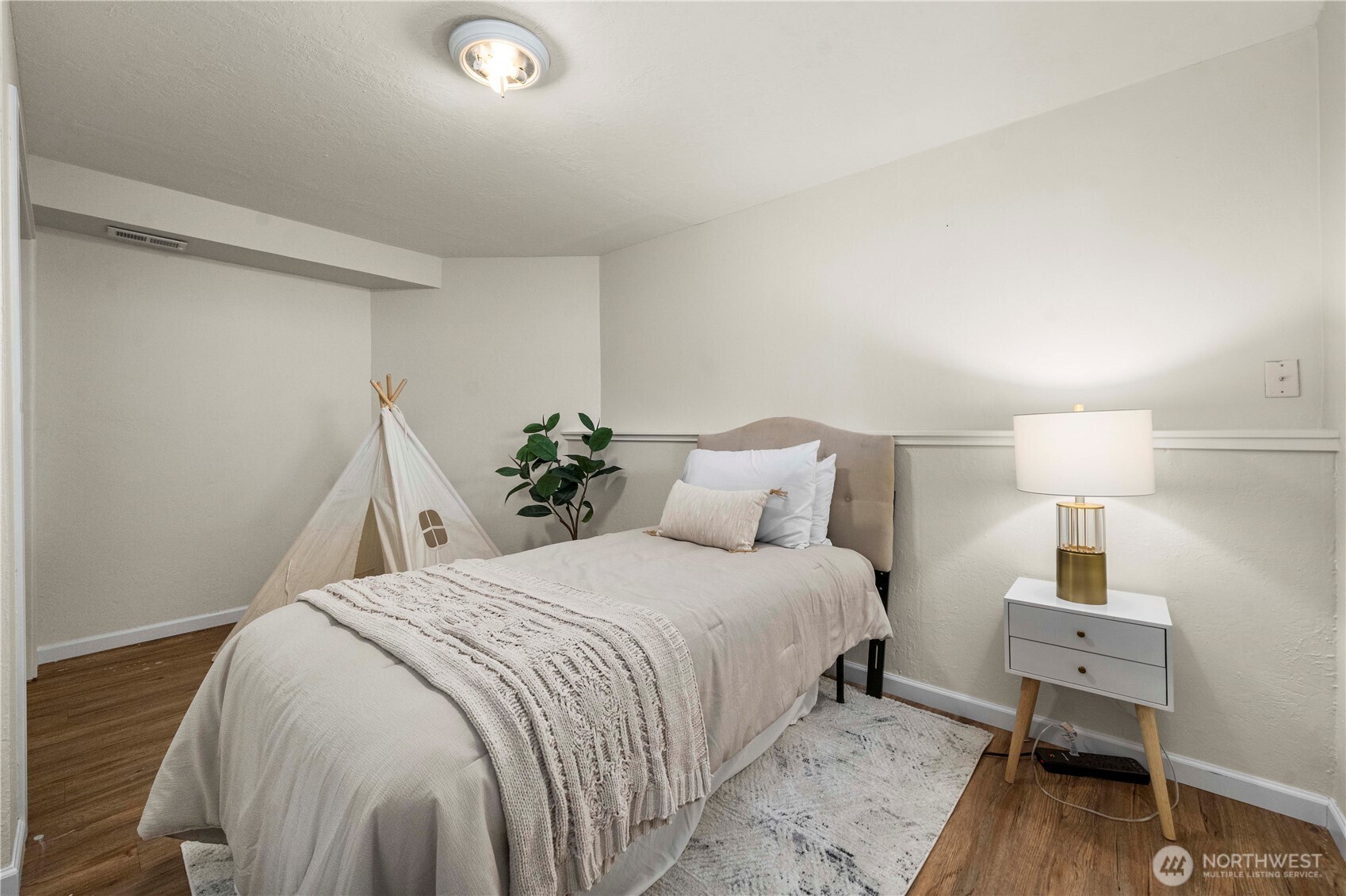 31611 37th Avenue Southwest Federal Way, WA 98023 - Photo 29 of 34 a bedroom with a bed and wooden floor