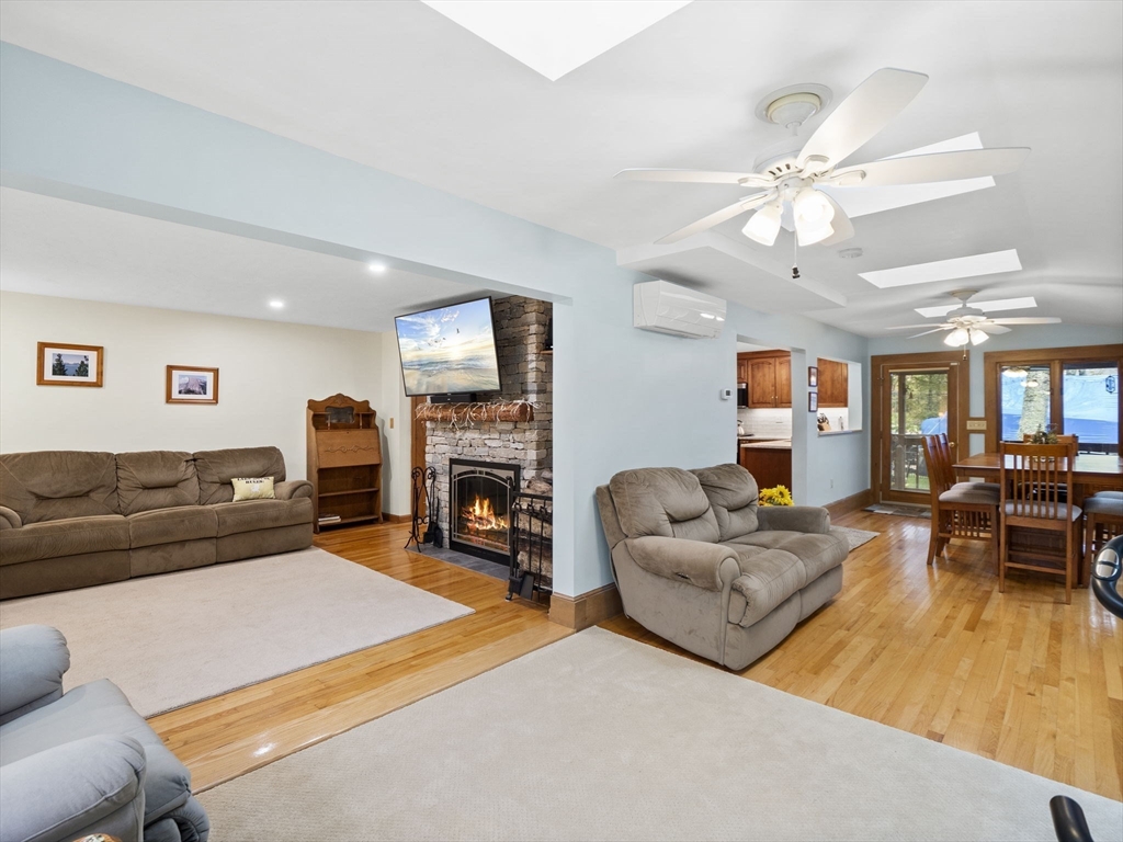 16 Blueberry Road Ashburnham, MA 01430 - Photo 13 of 42 a living room with furniture a fireplace and a flat screen tv
