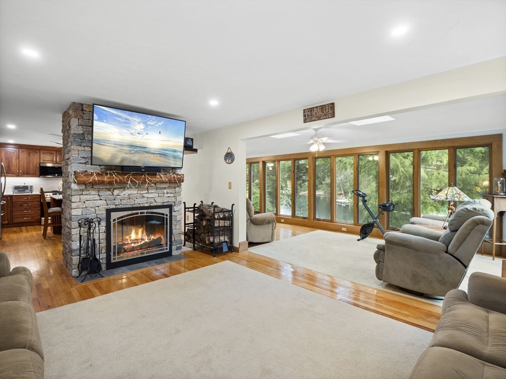 16 Blueberry Road Ashburnham, MA 01430 - Photo 15 of 42 a living room with furniture large windows and a fireplace