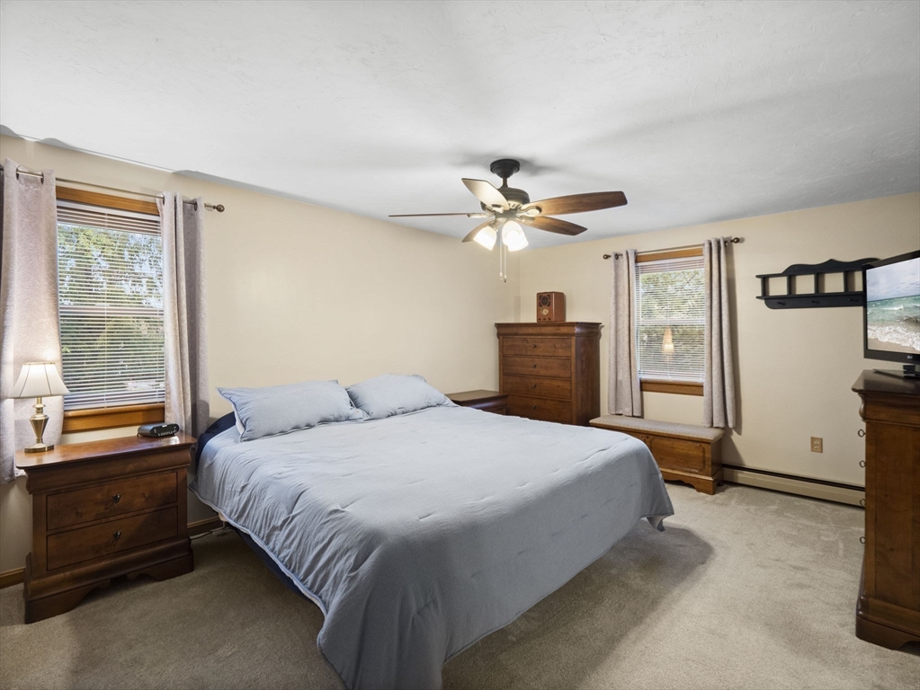 16 Blueberry Road Ashburnham, MA 01430 - Photo 20 of 42 a bedroom with a large bed and a chandelier