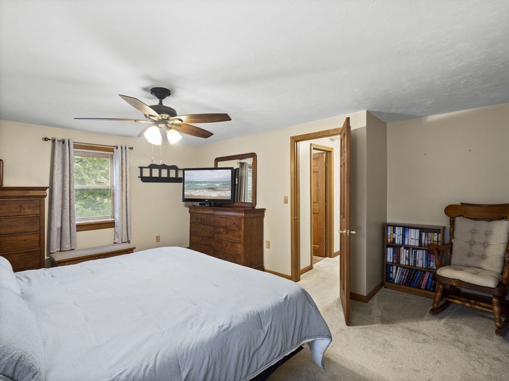 16 Blueberry Road Ashburnham, MA 01430 - Photo 21 of 42 a bedroom with a bed and a chandelier
