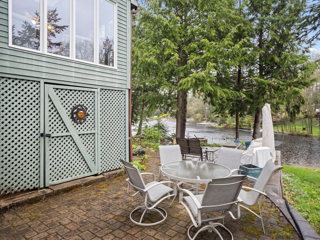 16 Blueberry Road Ashburnham, MA 01430 - Photo 24 of 42 a view of a patio with table and chairs and wooden fence