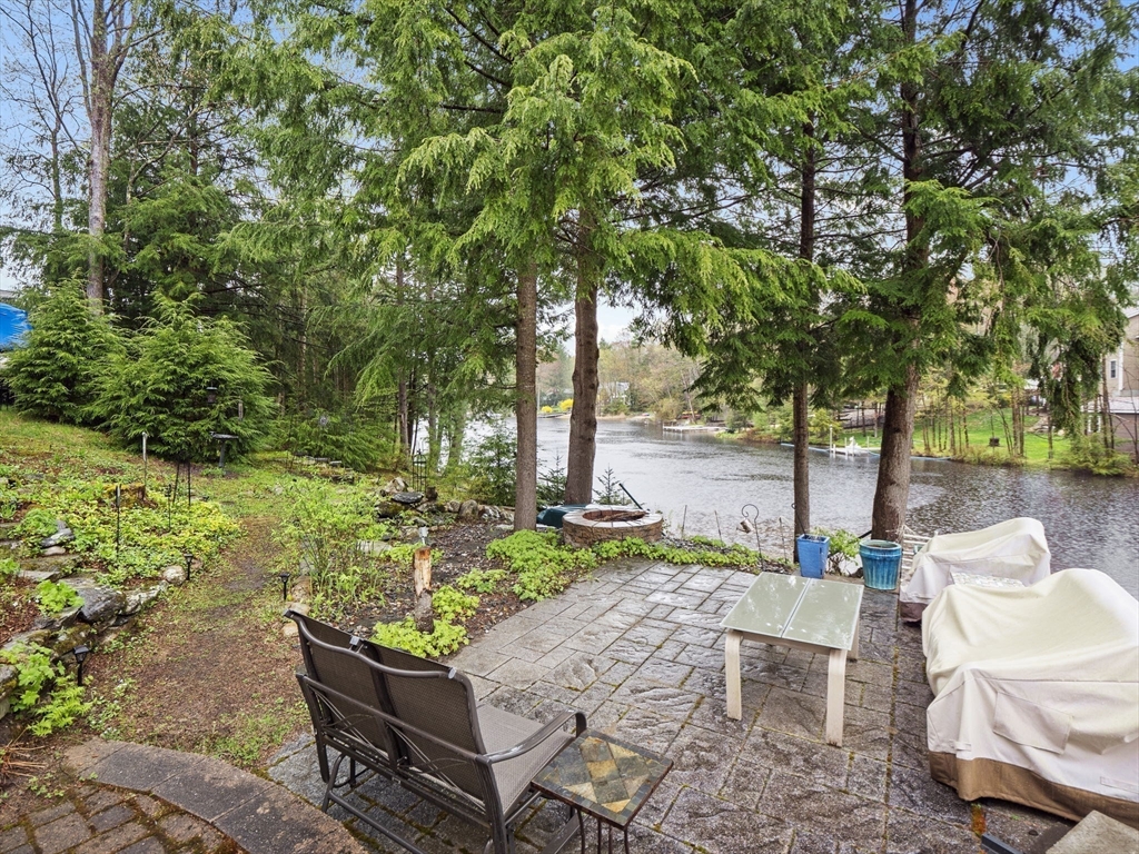 16 Blueberry Road Ashburnham, MA 01430 - Photo 25 of 42 a wooden bench sitting in the middle of a garden