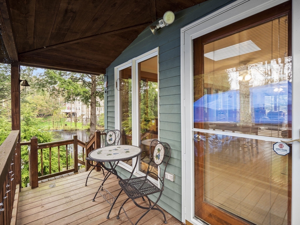 16 Blueberry Road Ashburnham, MA 01430 - Photo 30 of 42 a view of a balcony with chairs and wooden floor