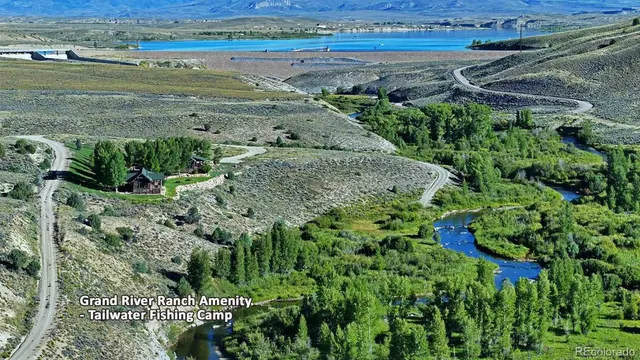 a living room with furniture a rug and a floor to ceiling window