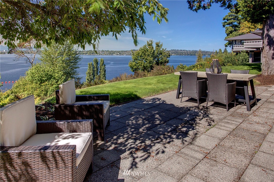 3217 Evergreen Point Road Medina, WA 98039 - Photo 2 of 25 a view of a patio with table and chairs potted plants and large tree