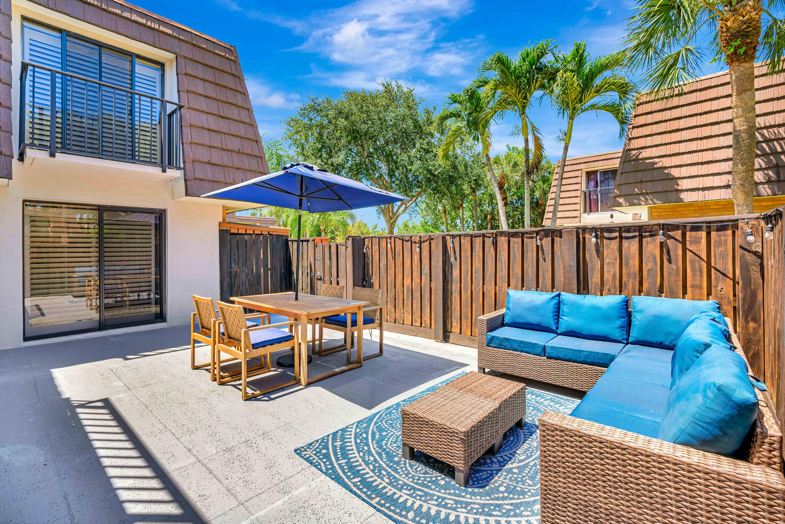 a backyard of a house with table and chairs