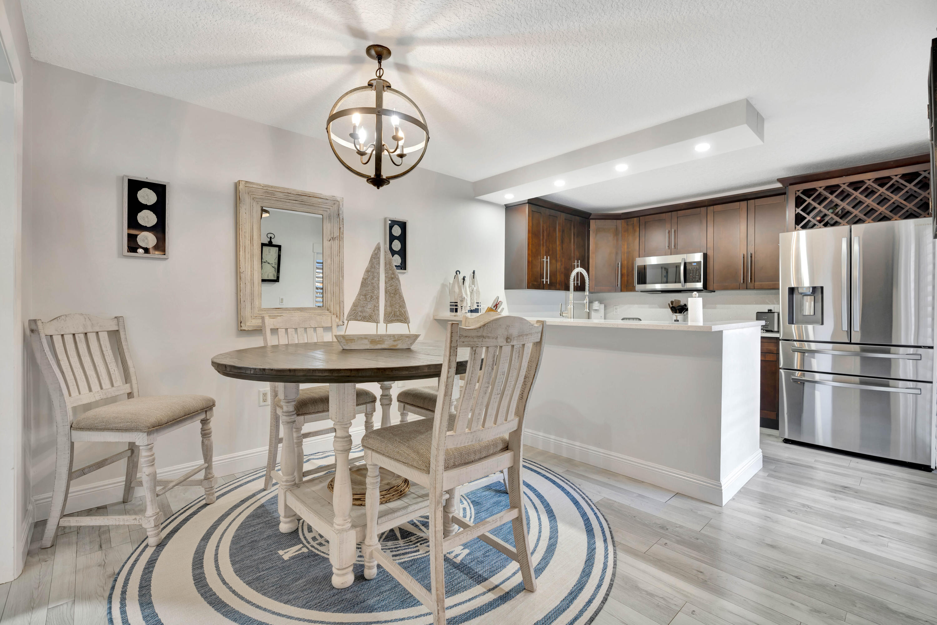 1209 12th Court Jupiter, FL 33477 - Photo 11 of 31 a view of a dining room with furniture a chandelier and wooden floor