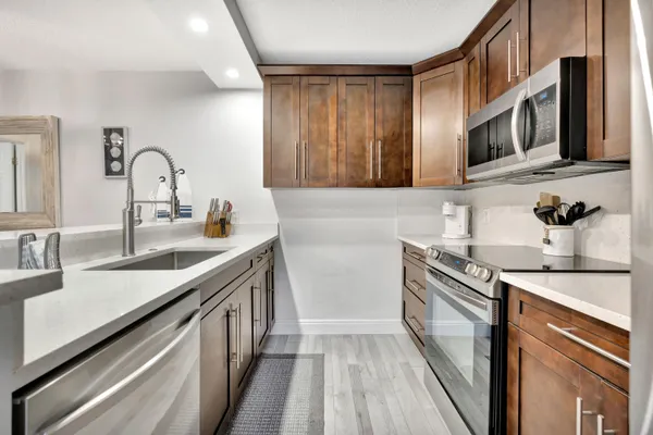a kitchen with stainless steel appliances granite countertop a sink and a stove